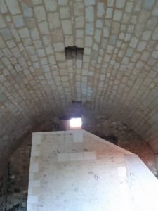 inside of the Castle of Montendre with stairs and an opening